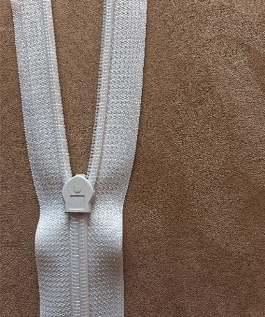 Replacement No. 5 zip sewn into the back of a wedding dress bodice, showing a wider chain and heavier slider